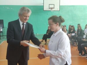 Wychowawca wręcza świadectwo uczniowi